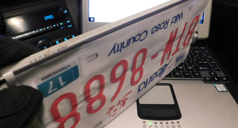 Fake licence plates printed on paper are pictured.