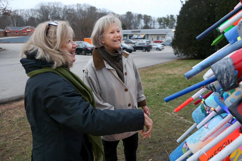 From left, Fuel and More president Maureen Bilodeau and former president and current secretary Linda Browning admire the buoy tree in Kittery on Tuesday, Dec. 6, 2022.
