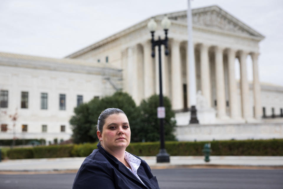 Shanna Hayes poses for a photograph at the U.S. Supreme Court, ahead of a case to reinstate U.S. President Biden’s debt cancellation plan, in Washington, U.S., February 22, 2023. REUTERS/Tom Brenner