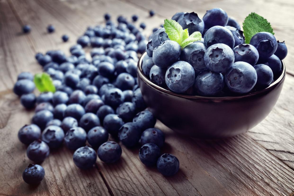 Blueberry antioxidant organic superfood in a bowl on a rustic table concept for healthy eating and nutrition