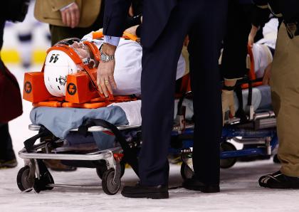 BOSTON, MA - DECEMBER 07: Brooks Orpik #44 of the Pittsburgh Penguins is carted off of the ice on a stretcher by the medical staff in the first period after an altercation with Shawn Thornton #22 of the Boston Bruins during the game at TD Garden on December 7, 2013 in Boston, Massachusetts. (Photo by Jared Wickerham/Getty Images)