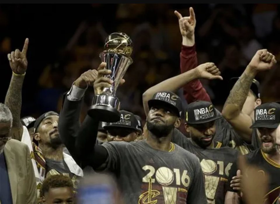 LeBron James hoists the NBA Finals Most Valuable Player Award after the Cavs won the NBA Finals in 2016.