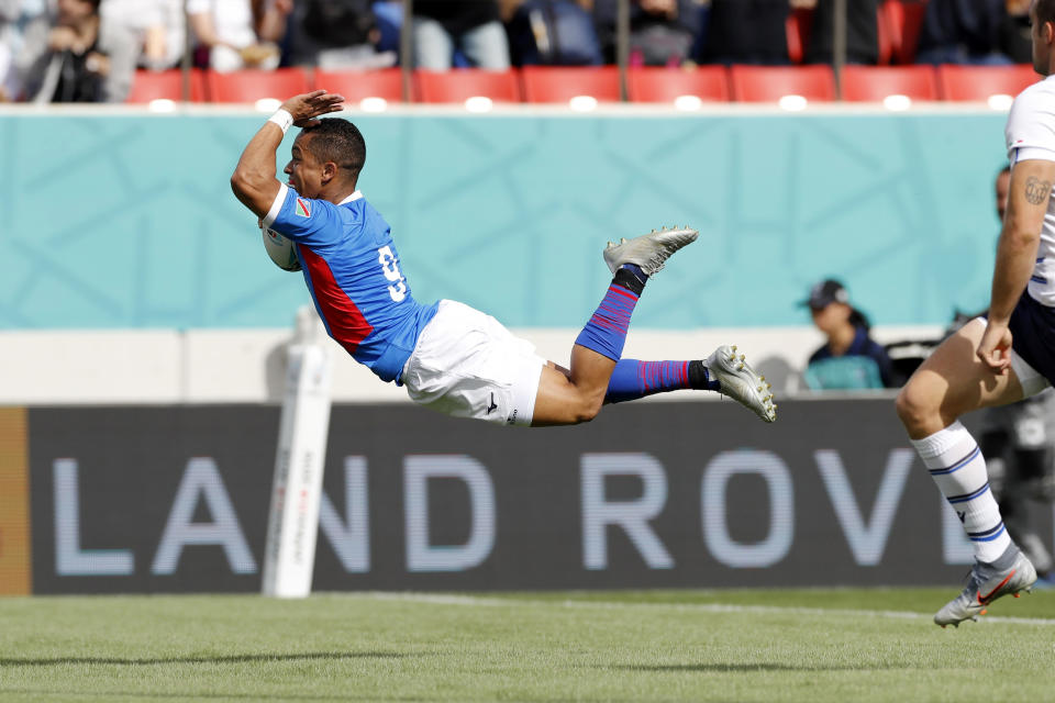 Namibia’s Damian Stevens dives to score a try against Italy during the Rugby World Cup Pool B game between Italy and Namibia in Osaka, western Japan, Sunday, Sept. 22, 2019. (Yuki Sato/Kyodo News via AP)