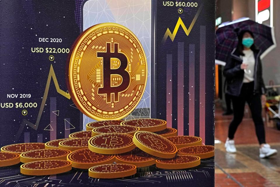 An advertisement for Bitcoin cryptocurrency is displayed on a street in Hong Kong, on Feb. 17, 2022. Cryptocurrency trading company FTX, which announced it had acquired the Calgary-based Bitvo Inc. in June, said it was entering bankruptcy proceedings on Friday.