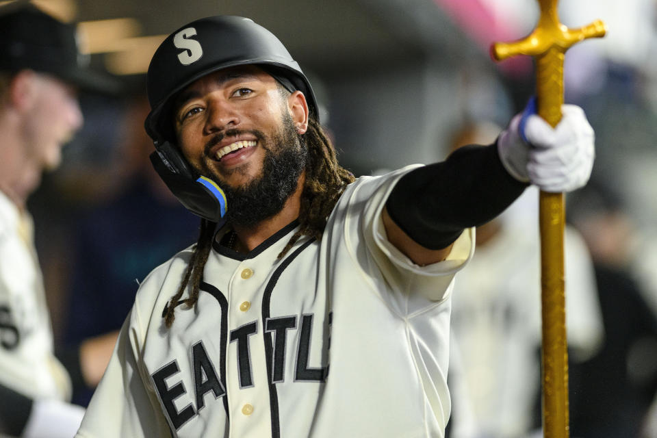 Seattle Mariners' J.P. Crawford celebrates after his solo home run against the Chicago White Sox in the dugout during the first inning of a baseball game, Saturday, June 17, 2023, in Seattle. (AP Photo/Caean Couto)