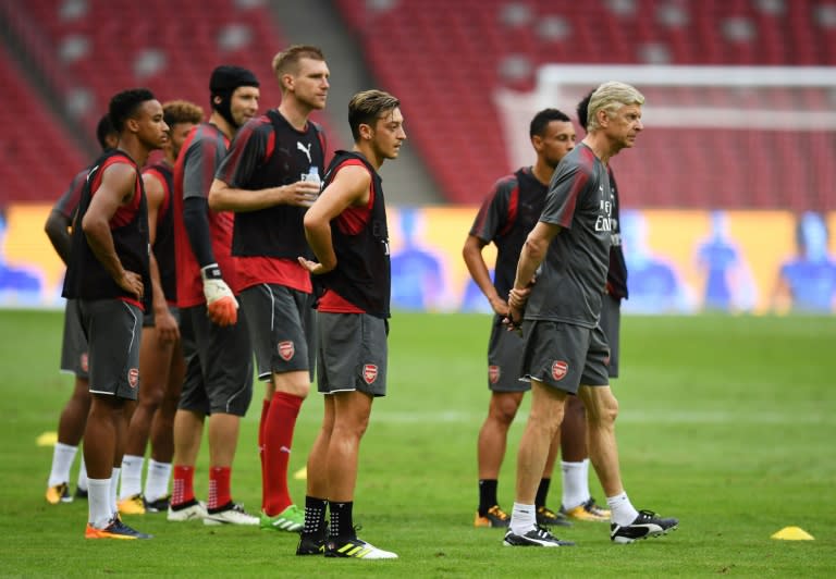 Arsenal manager Arsene Wenger (R) says his team would take the Europa League competition seriously despite the disappointment of missing out on the Champions League