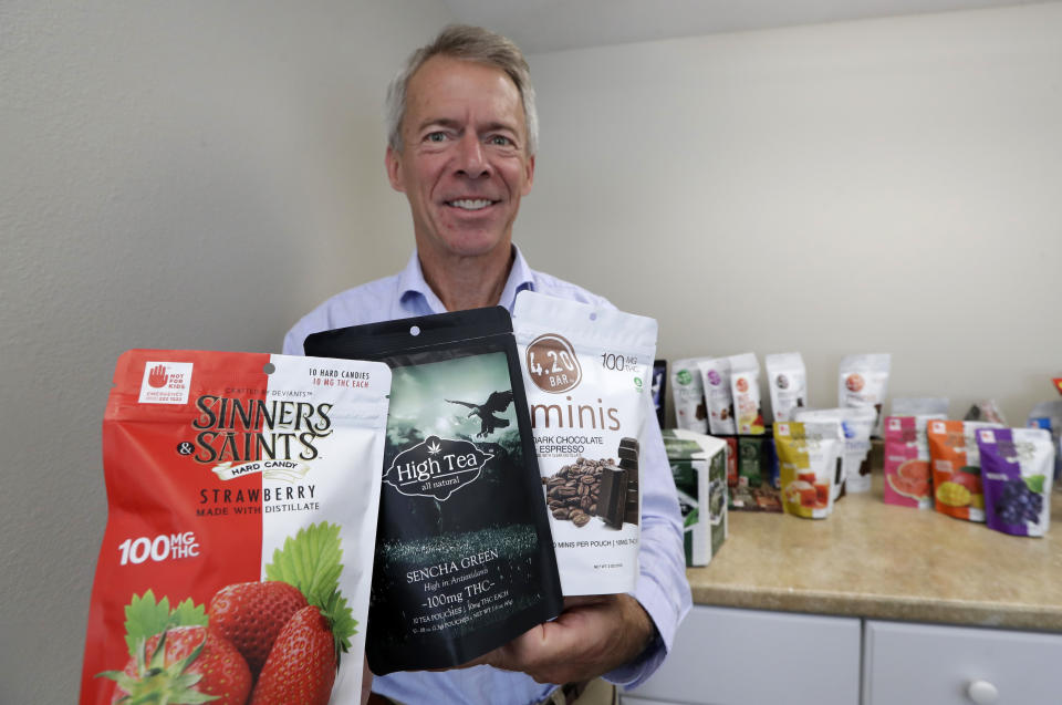 Andy Brassington, chief financial officer at Evergreen Herbal, displays a few of his company's cannabis-infused products, Wednesday, July 24, 2019, in Seattle. Washington state's marijuana regulators have eased some requirements regarding the "seed to sale" tracking of the drug, a week after a botched software update began preventing many business from being able to ship their products, cost hundreds of thousands of dollars in lost sales and prompted some to furlough workers. (AP Photo/Elaine Thompson)