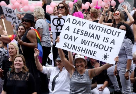 Participants hold banners during the annual gay pride parade in Amsterdam