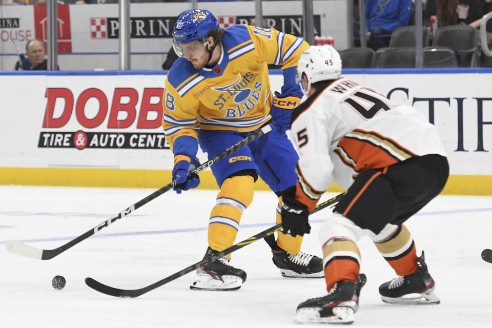 St. Louis Blues' Robert Thomas (18) works the puck against Anaheim Ducks' Colton White (45) during the second period of an NHL hockey game Monday, Nov. 21, 2022, in St. Louis. (AP Photo/Michael Thomas)