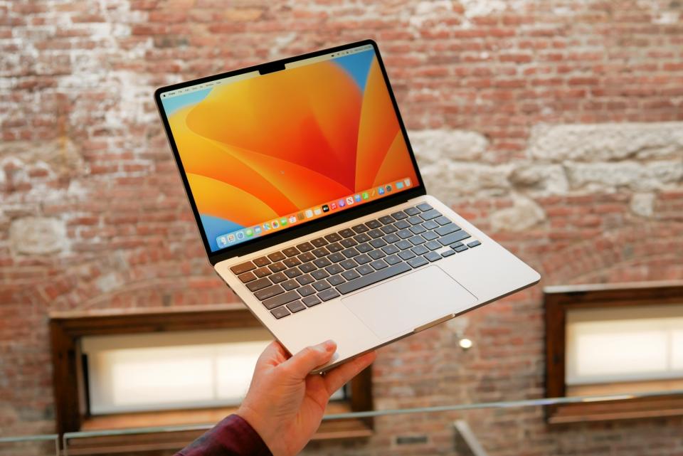 Apple MacBook Pro 13-inch with M2 Max held in hand