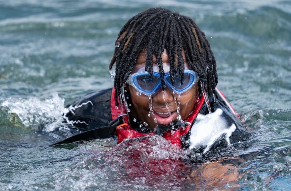 Nicholas Young, 11, of Detroit, cools off in the Detroit River after a hot day of sailing with the Challenge the Wind program on Thursday, July 20, 2023, from the banks of the Belle Isle Boat House.