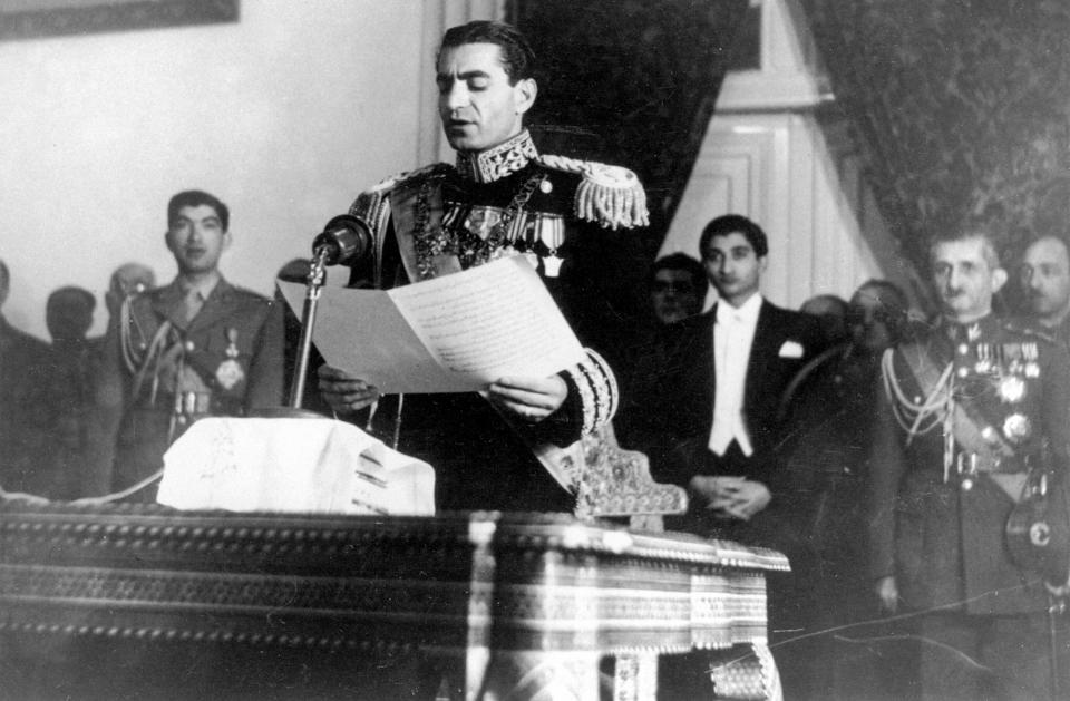 FILE - In this Feb. 16, 1950 file photograph, the Shah of Iran Mohammad Reza Pahlavi reads his inaugural speech at the initial session of his nation's first senate in Tehran, Iran. The fall of the Peacock Throne and the rise of the Islamic Revolution in Iran grew out of the shah’s ever-tightening control over the country as other Middle East monarchies toppled. (AP Photo, File)