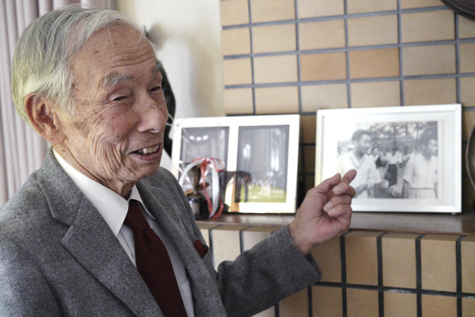 In this Feb. 3, 2019, photo, Kazuo Oda, a retired trading house executive and longtime tennis friend of Emperor Akihito, speaks on a photograph showing Oda with then Crown Price Akihito and Michiko Shoda, who become Empress Michiko, during an exclusive interview with the Associated Press in Tokyo. Akihito’s Heisei era will end when he abdicates on April 30 in favor of his elder son, 58-year-old Crown Prince Naruhito, beginning a new, as yet unnamed era. (AP Photo/Eugene Hoshiko)