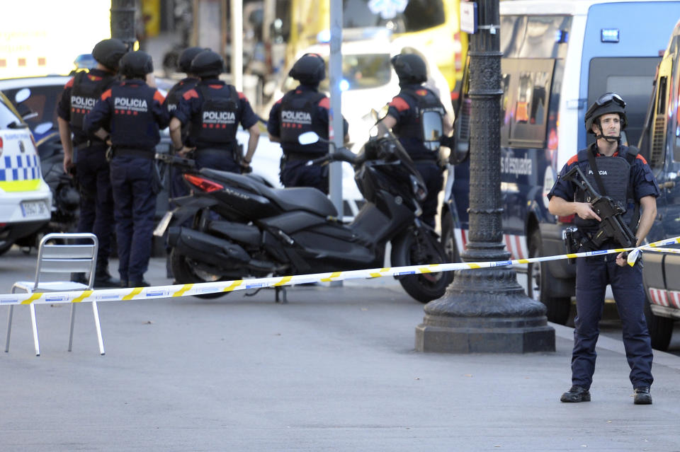 Armed policemen&nbsp;stand in a cordoned-off area.