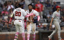 Atlanta Braves' Marcell Ozuna (20) congratulates Ronald Acuna Jr. after Acuna scored against the Philadelphia Phillies in the first inning of a baseball game Sunday, May 9, 2021, in Atlanta. (AP Photo/Ben Margot)