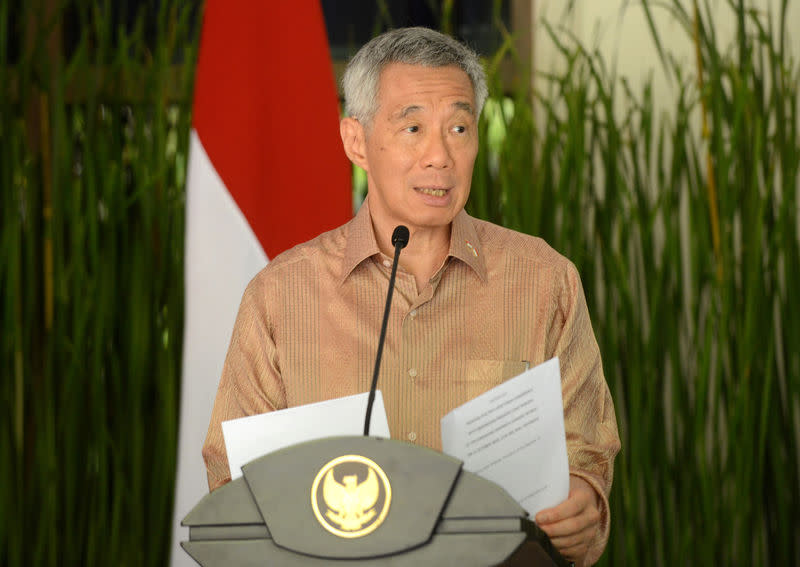 Singapore's Prime Minister Lee Hsien Loong speaks to journalist after bilateral meeting on the International Monitary Fund and World Bank annual meetings in Nusa Dua