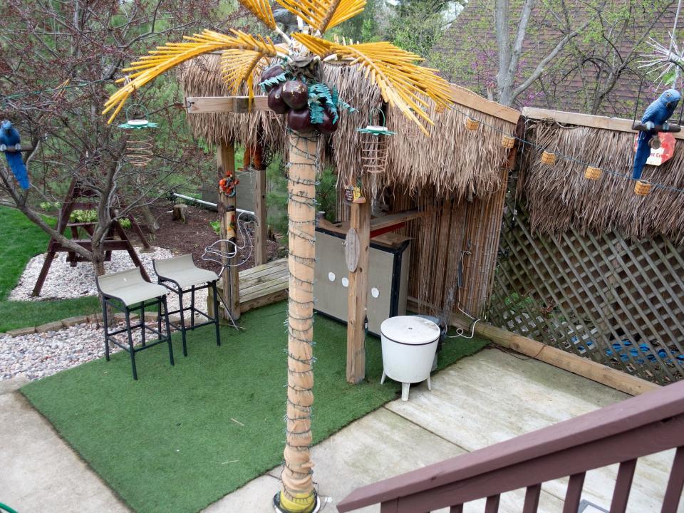 decorative tiki bar area in someone's backyard