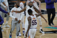 Phoenix Suns guard E'Twaun Moore (55) celebrates with teammates after his winning score against the San Antonio Spurs during the second half of an NBA basketball game against the San Antonio Spurs in San Antonio, Sunday, May 16, 2021. (AP Photo/Eric Gay)