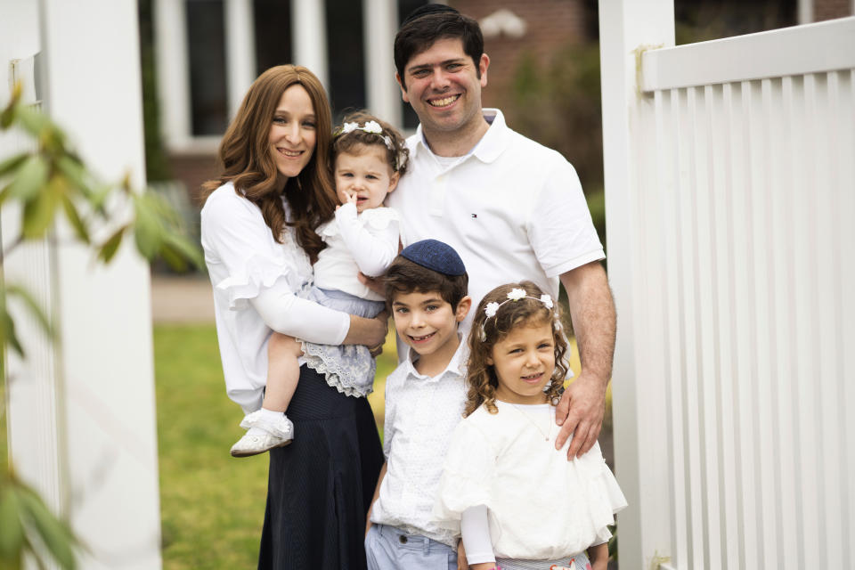 This undated image released by Maggie Hellman shows Hellman with her husband Jeremy and their three children, from left, Gili, 2, Yehuda, 7, and Elisheva, 5, at their New Jersey home. The coronavirus outbreak is having an impact on couples and their relationships. Maggie Hellman created a Facebook group for her friends to blow off their own steam. (Abbie Sophia Photography/Maggie Hellman via AP)