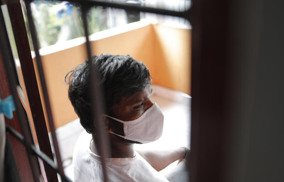 Sri Lankan auto rickshaw driver Prasad Dinesh, linked by Sri Lankan officials to nearly half the country's more than 2,600 coronavirus cases, sits in his house in Ja-Ela, Sri Lanka, Wednesday, July 1, 2020. For months he’s been anonymous, but now Dinesh is trying to clear his name and shed some of the stigma of a heroin addiction at the root of his ordeal. Referring to him only as “Patient 206,” government officials lambasted Dinesh on TV and social media, blaming him for at least three clusters of cases, including about 900 navy sailors who were infected after an operation in Ja-Ela, a small town about 19 kilometers (12 miles) north of the capital, Colombo. Dinesh, however, says his drug addiction, which is considered a crime in Sri Lanka, makes him a convenient scapegoat. (AP Photo/Eranga Jayawardena)