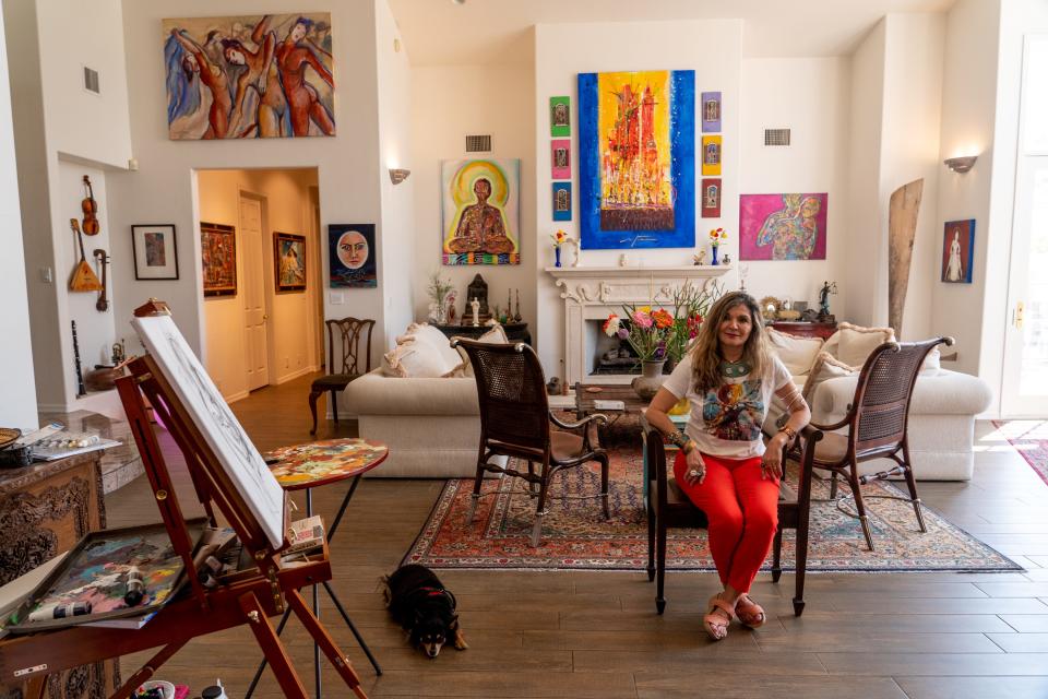 Artist Mitra Kamali and her dog Lucy pose for a portrait inside her home in Scottsdale on April 25, 2023.