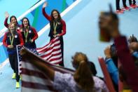 2016 Rio Olympics - Swimming - Victory Ceremony - Women's 4 x 200m Freestyle Relay Victory Ceremony - Olympic Aquatics Stadium - Rio de Janeiro, Brazil - 10/08/2016. Allison Schmitt (USA) of USA, Leah Smith (USA) of USA, Maya DiRado (USA) of USA and Katie Ledecky (USA) of USA wave to fans after receiving their gold medals. REUTERS/Marcos Brindicci