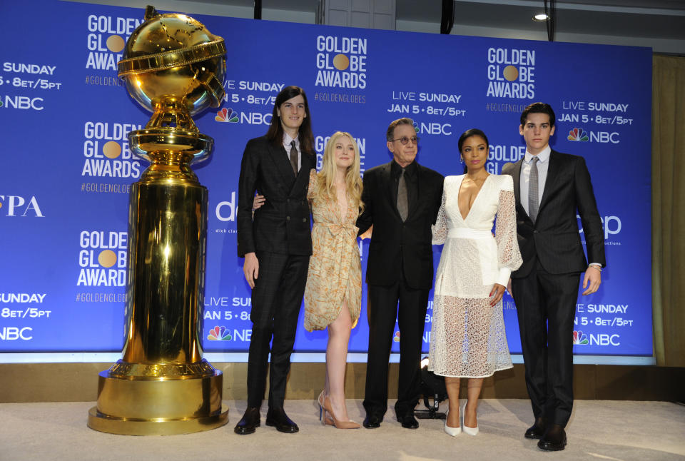 Golden Globe Ambassadors Paris Brosnan, right, and Dylan Brosnan, from left, pose with presenters Dakota Fanning, Tim Allen and Susan Kelechi Watson on stage following the nominations for the 77th annual Golden Globe Awards at the Beverly Hilton Hotel on Monday, Dec. 9, 2019, in Beverly Hills, Calif. The 77th annual Golden Globe Awards will be held on Sunday, Jan. 5, 2020. (AP Photo/Chris Pizzello)