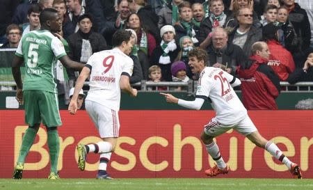 Bayern Munich's Thomas Mueller (R) celebrates after scoring the opening goal during the German Bundesliga first division soccer match against Werder Bremen in Bremen, October 17, 2015. REUTERS/Fabian Bimmer.