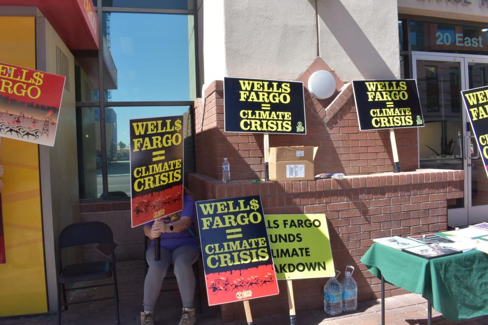 Members of Phoenix's Extinction Rebellion protest Wells Fargo's financing of fossil fuels emissions outside of a branch in downtown Tempe