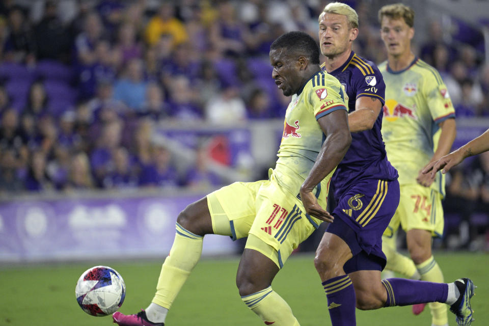 New York Red Bulls forward Elias Manoel (11) attempts a shot on goal in front of Orlando City defender Robin Jansson (6) during the first half of an MLS soccer match Saturday, Feb. 25, 2023, in Orlando, Fla. (AP Photo/Phelan M. Ebenhack)