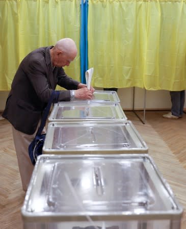 A voter casts his ballot at a polling station during Ukraine's parliamentary election in Kiev