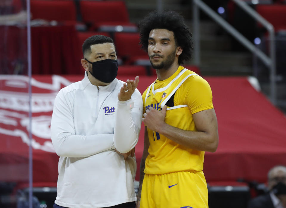 Pittsburgh's head coach Jeff Capel talks with Justin Champagnie (11) after a technical was assessed during the first half of an NCAA college basketball game in Raleigh, N.C., Sunday, Feb. 28, 2021. (Ethan Hyman/The News & Observer via AP)