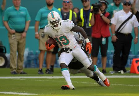 Sep 23, 2018; Miami Gardens, FL, USA; Miami Dolphins wide receiver Jakeem Grant (19) is defended by Oakland Raiders defensive back Marcus Gilchrist (31) on a 52-yard touchdown reception in the fourth quarter at Hard Rock Stadium. The Dolphins defeated the Raiders 28-20. Mandatory Credit: Kirby Lee-USA TODAY Sports