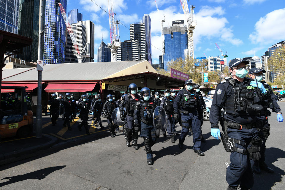 Dozens of police are seen marching through the city.