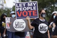 Supporters of restoring Florida felons' voting rights march to an early voting precinct, Saturday, Oct. 24, 2020, in Fort Lauderdale, Fla. The Florida Rights Restoration Coalition led marches to the polls in dozens of Florida counties. (AP Photo/Marta Lavandier)