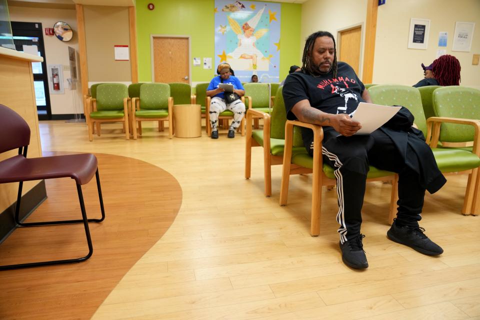 Craig Carrington waits for his medication after visiting his doctor at Millvale Health Center, which has an in-house pharmacy.