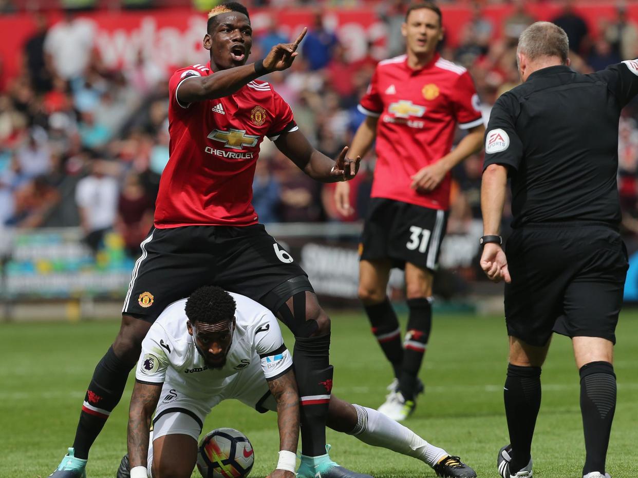 Paul Pogba appeals against receiving a booking after fouling Leroy Fer in Manchester United's win over Swansea: Getty