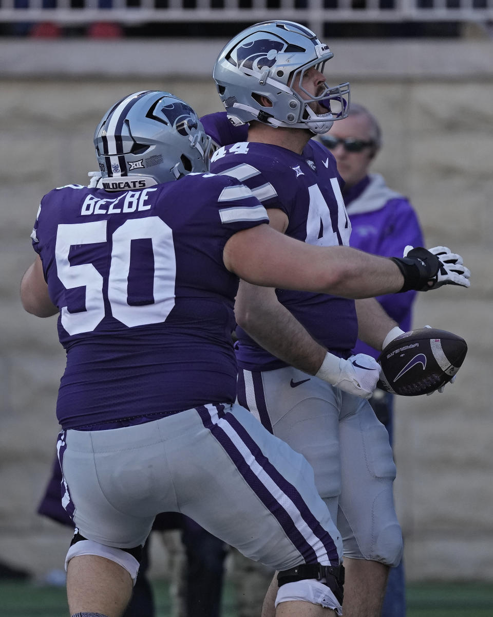 Kansas State tight end Christian Moore (44) celebrates with offensive lineman Cooper Beebe (50) after scoring a touchdown during the first half of an NCAA college football game against Baylor Saturday, Nov. 11, 2023, in Manhattan, Kan. (AP Photo/Charlie Riedel)