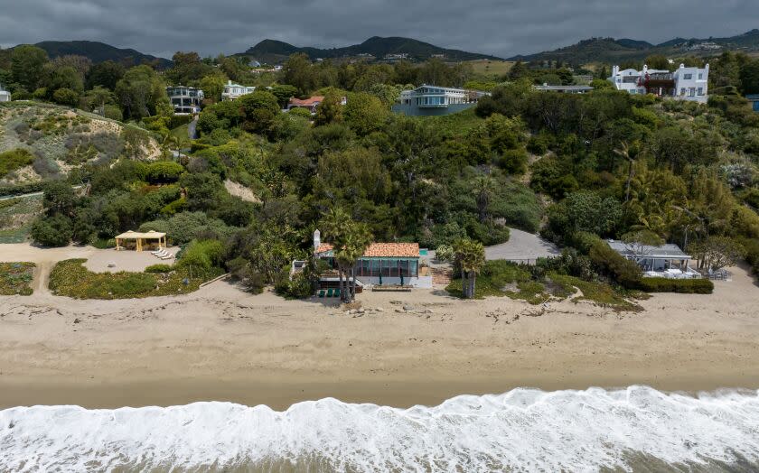 Malibu, CA - May 31: The owners of the properties at 27910 Pacific Coast Highway, center, and 27920 Pacific Coast Highway, left, installed fences, driveways, dumpsters and landscaping along the highway to obscure the public easement to Escondido Beach on Wednesday, May 31, 2023 in Malibu, CA. (Brian van der Brug / Los Angeles Times)