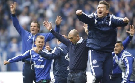 FC Schalke 04's coach Roberto Di Matteo (C) and team members celebrate a goal against VfB Stuttgart during their Bundesliga first division soccer match in Gelsenkirchen, Germany May 2, 2015. REUTERS/Ina Fassbender