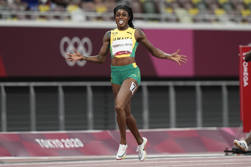 Elaine Thompson-Herah, of Jamaica, celebrates after winning the final of the women's 200-meters at the 2020 Summer Olympics, Tuesday, Aug. 3, 2021, in Tokyo. (AP Photo/David Goldman)