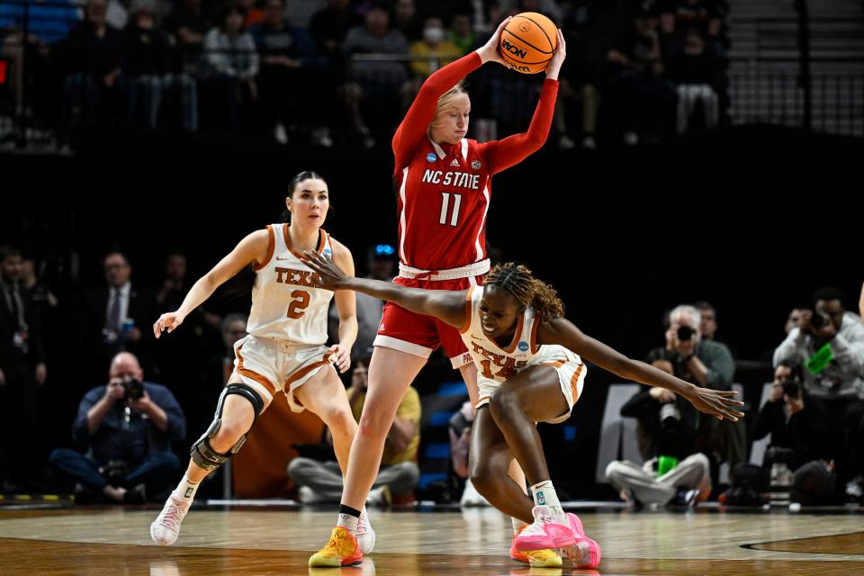 Mar 31, 2024; Portland, OR, USA; NC State Wolfpack center River Baldwin (1) controls the ball during the first half against Texas Longhorns forward Amina Muhammad (14) and guard Shaylee Gonzales (2) in the finals of the Portland Regional of the NCAA Tournament at the Moda Center center. Mandatory Credit: Troy Wayrynen-USA TODAY Sports
