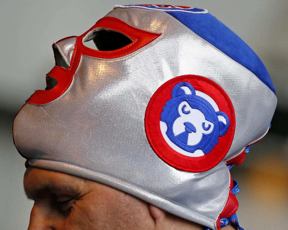 A fan wears a mask before a baseball game between the Chicago Cubs and the Los Angeles Dodgers on home opening day, Monday, April 10, 2017, in Chicago. (AP Photo/Nam Y. Huh)