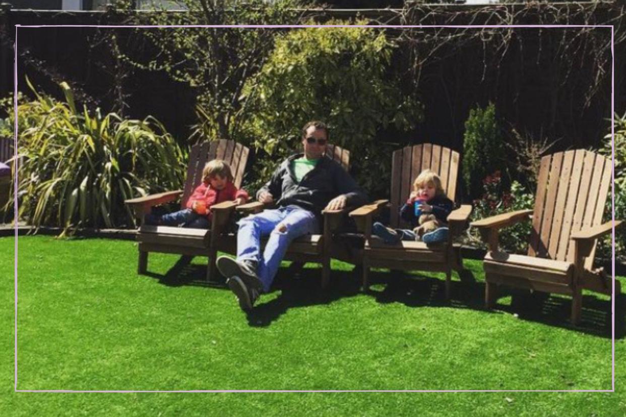  Dad sat on a chair with two children either side of him. 