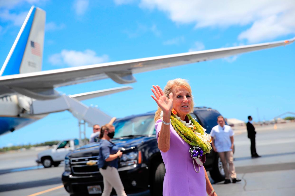 First Lady Jill Biden waves to the media on the tarmac after arriving at Joint Base Pearl Harbor-Hickam, Hawaii on Saturday, July 24, 2021.
