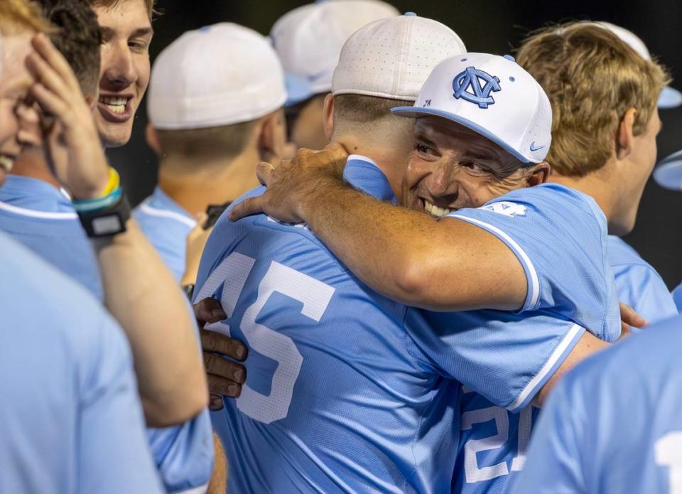 North Carolina coach Scott Forbes embraces first baseman Hunter Stokley (45) as they celebrate their 2-1 victory over West Virginia, clinching the Super Regional and advancing to the College World Series on Saturday, June 8, 2024 at Boshamer Stadium in Chapel Hill, N.C.