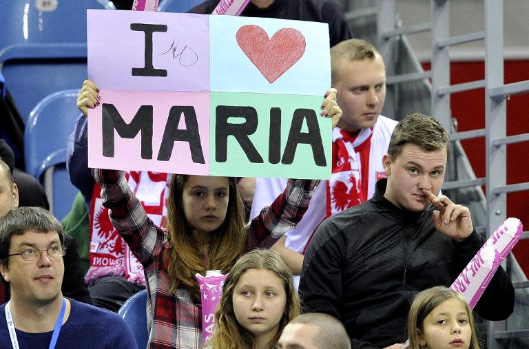 A fan holds up a sign during Maria Sharapova's Fed Cup match against Agnieszka Radwanska in Krakow, Poland on February 8, 2015