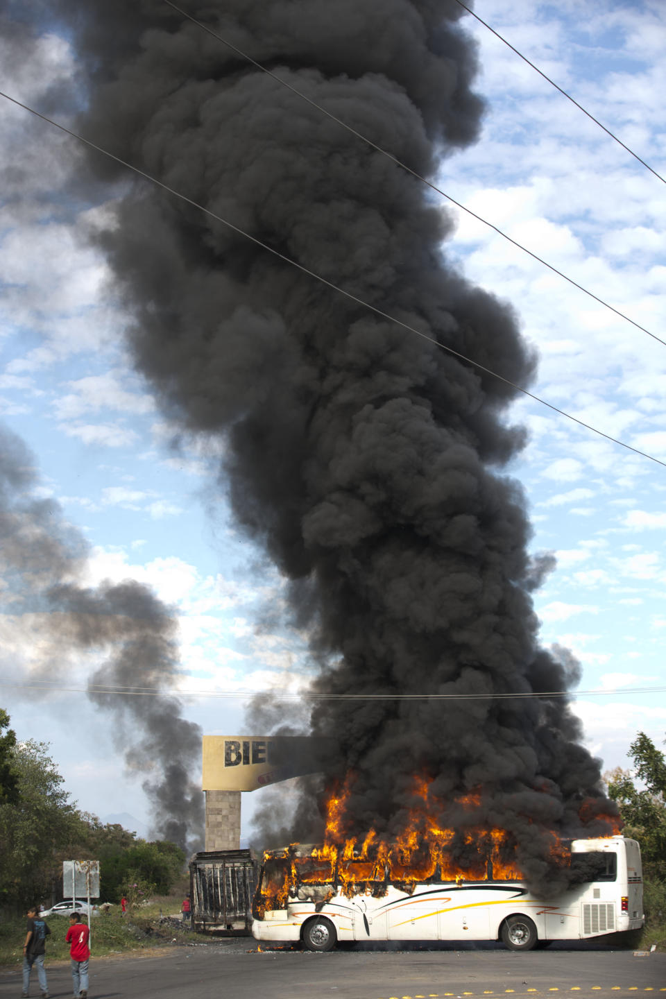 Un autobús arde a la entrada de la localidad de Parácuaro, estado de Michoacán, en México, el viernes 10 de enero de 2014, antes de la llegada de autodefensas que combaten a grupos narcotraficantes. (AP Foto/Eduardo Verdugo)