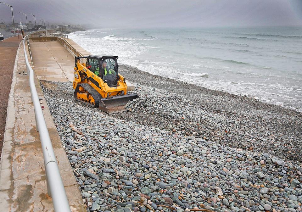 Stones are removed from access points at Nantasket Beach in Hull in April after winter storms pushed the stones against the sea wall.