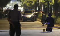 Members of bomb squad examine the site where an explosion that police said came from a firecracker, near the venue of the presidential candidates debate in Jakarta, Indonesia, Sunday, Feb. 17, 2019. Indonesia is gearing up to hold its presidential election on April 17 that will pit in the incumbent against the former general.(AP Photo / Achmad Ibrahim)